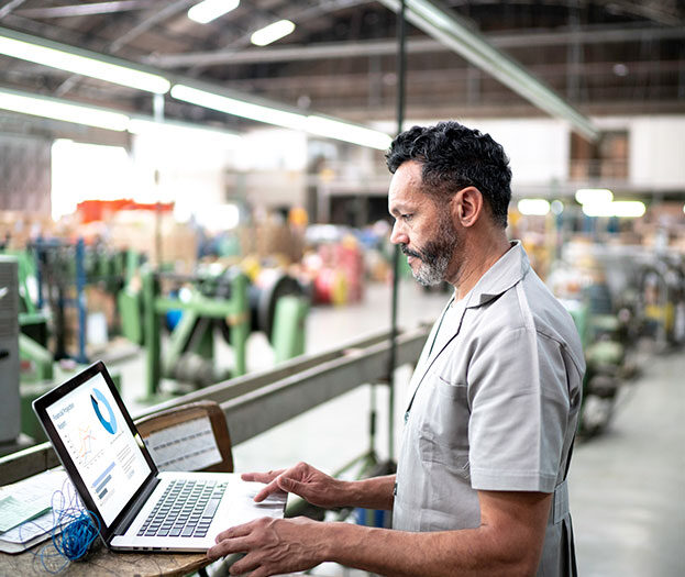 A male looking at a laptop. 